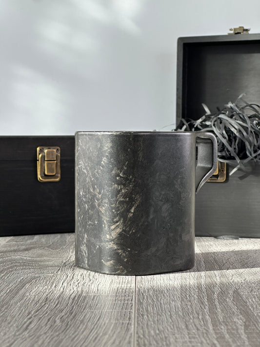 Forged carbon fibre mug – Quotidiano Edition 2 – with premium wooden boxes in background, angled rear view